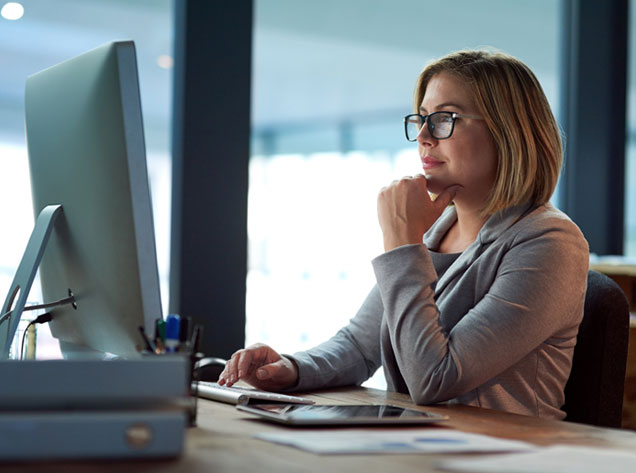 Woman staring at computer thinking the role we perform is handled with experience, precision, and care